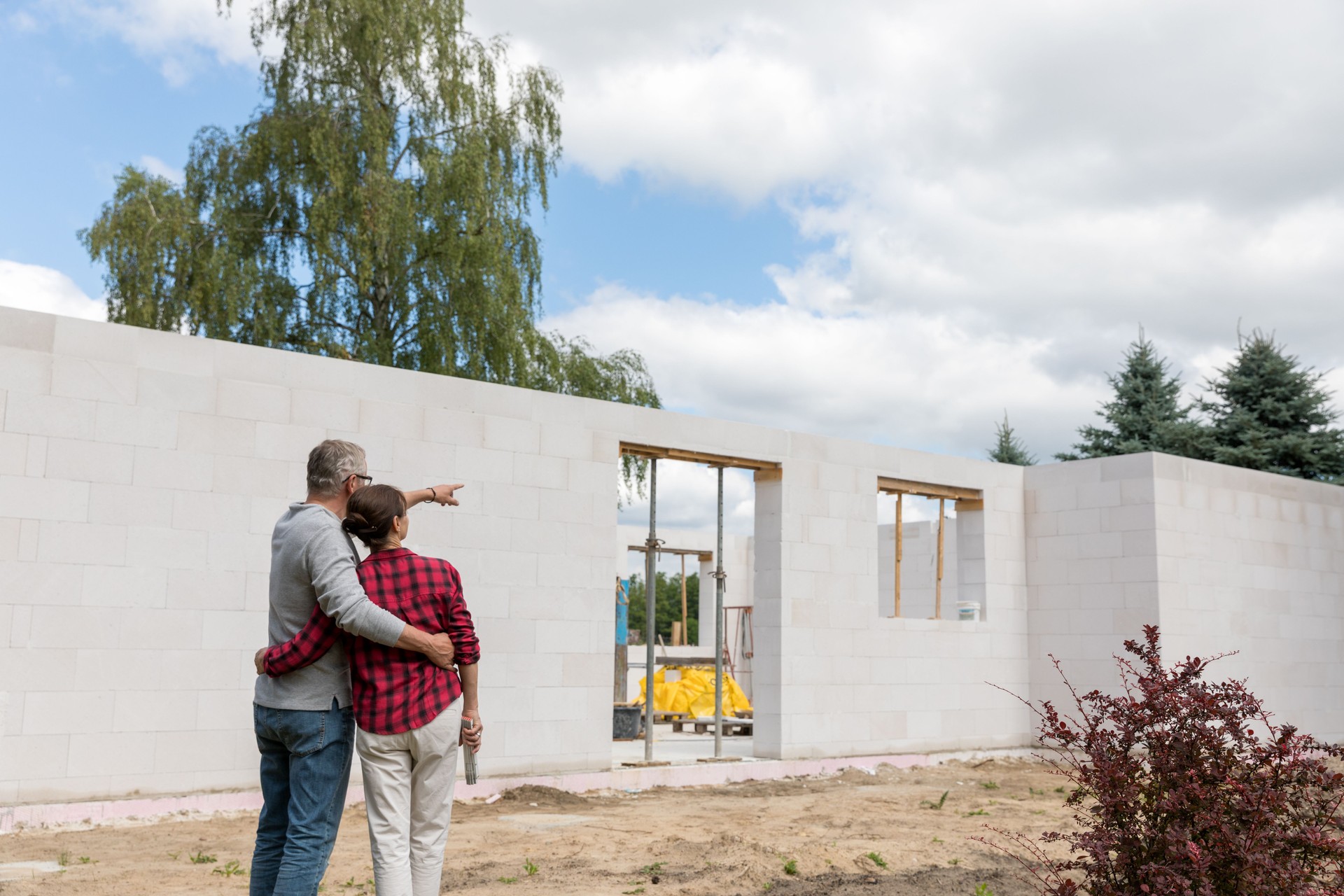 Couple on construction site of new house